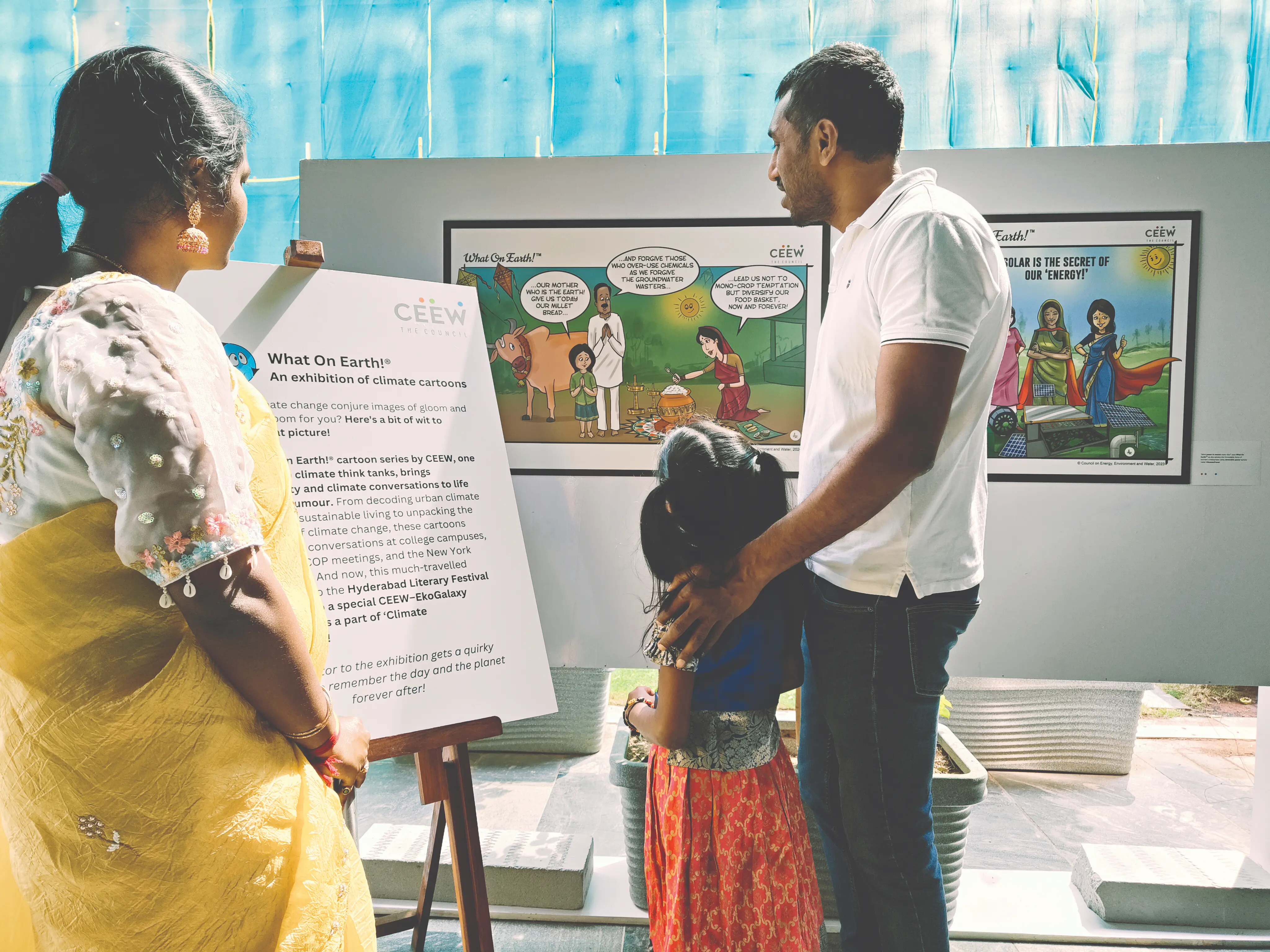 Visitors viewing an exhibition panel at a festival