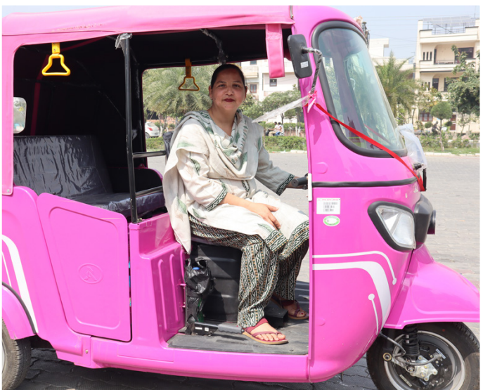 Raj in her pink electric three-wheeler